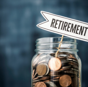 Glass jar full of coins with retirement label