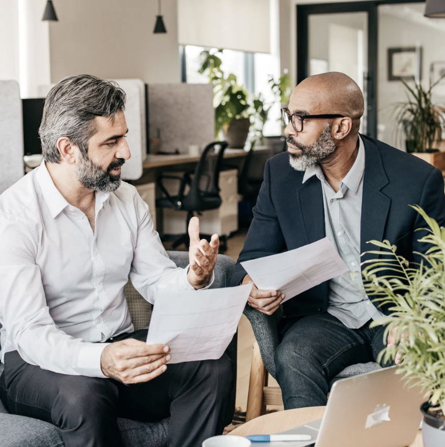 Two men discussion mutual funds in an office setting.