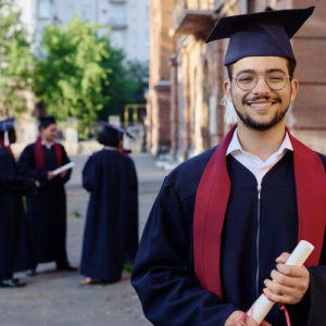 Boy wearing graduation hat and holding diploma